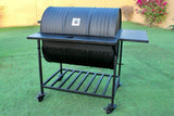 A large black metal charcoal grill with a 1.5mm thick removable tray and SS rod grills, displayed on a lawn.